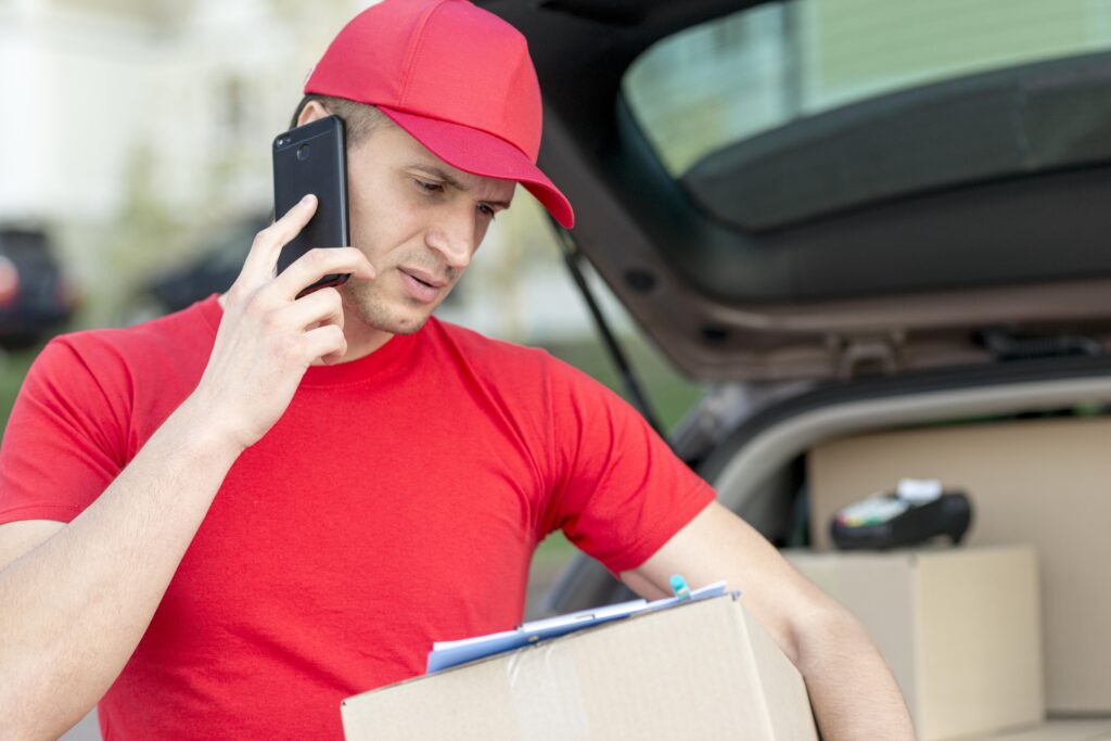 smiley delivery man with phone